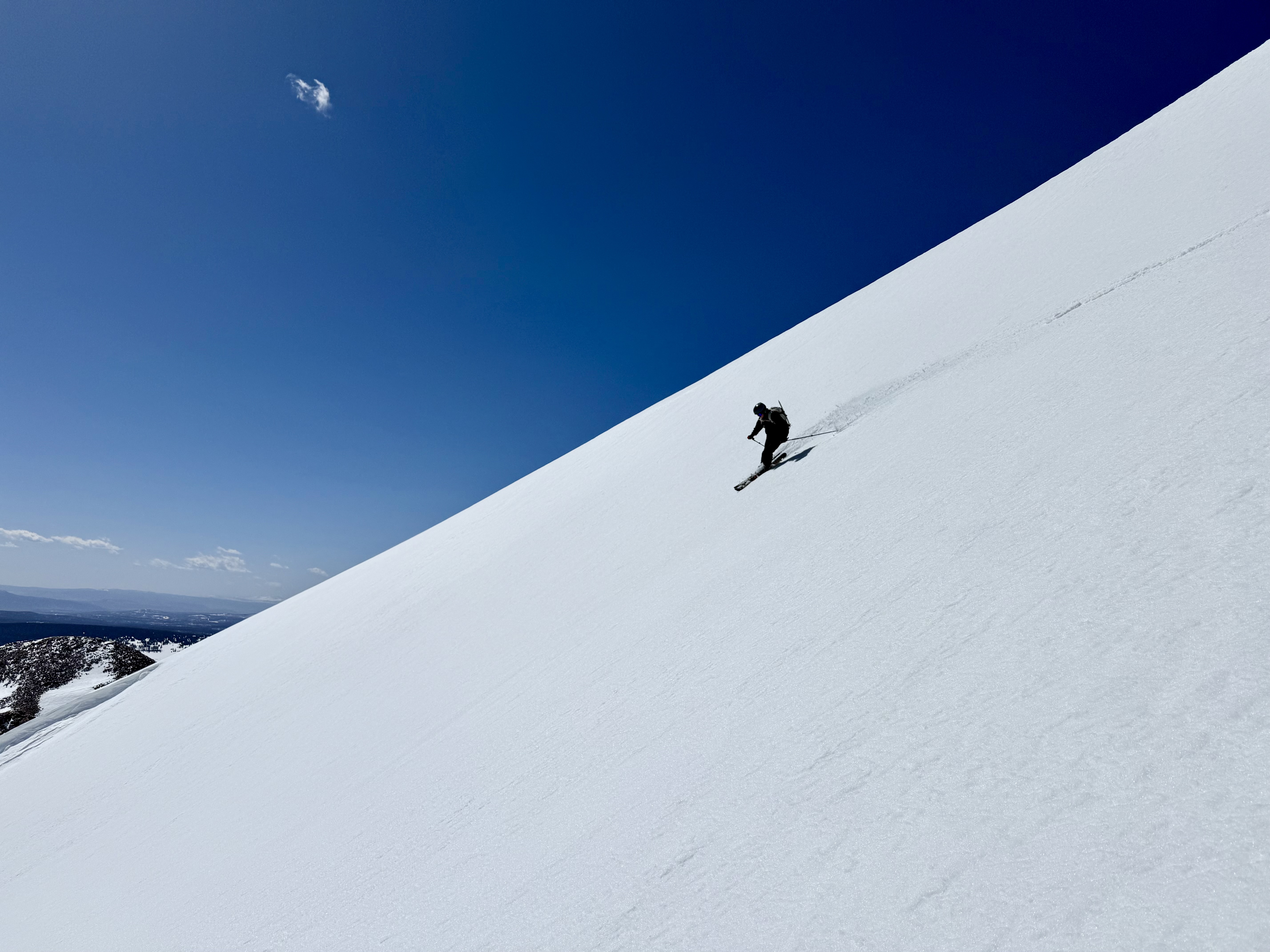 Person skiing in a wide open and white slope
